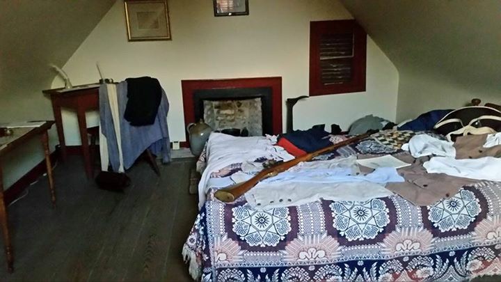 Attic bedroom with musket and quilt at Weems-Botts Museum